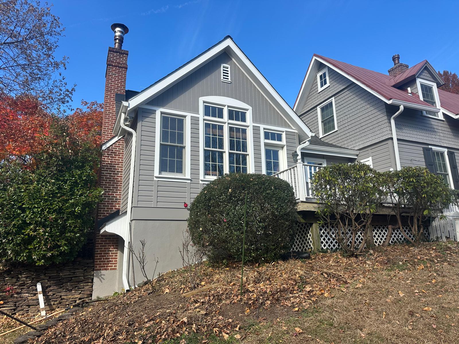 Freshly painted gray house exterior with white trim and brick chimney, Chester County, PA