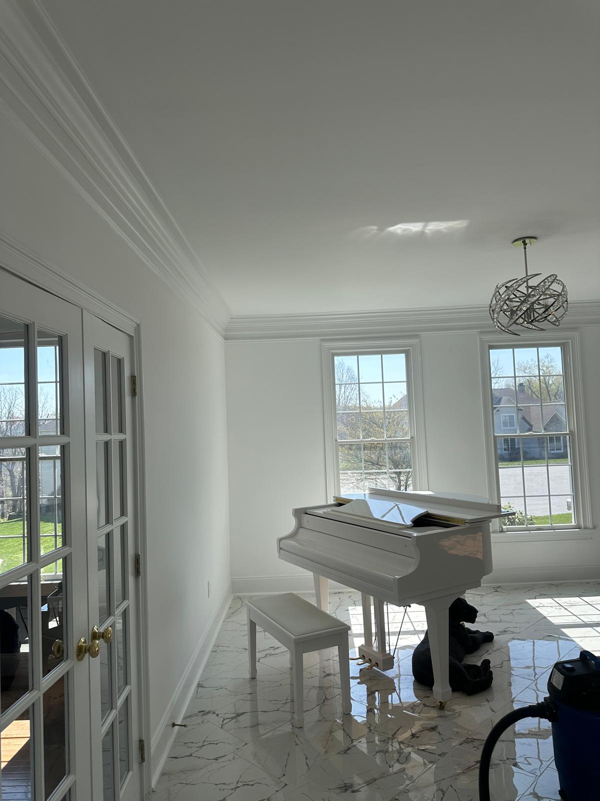 Bright finished living room with crown molding and marble floor, Coatesville, PA